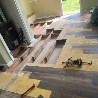 Flooring and subfloor removed to expose the floor joists underneath during mold remediation